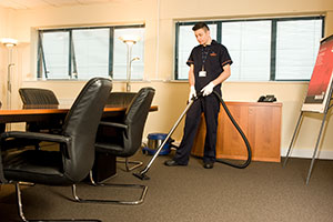 A Staff member cleaning the office Floor