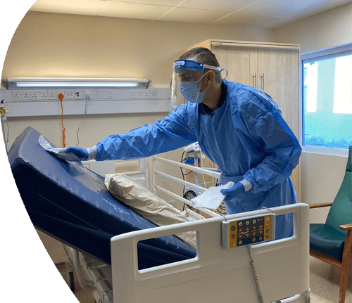 Person Cleaning Hospital Bed